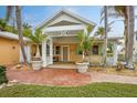 Charming tropical home with a covered porch and brick walkway at 306 55Th St, Holmes Beach, FL 34217