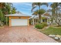 White garage door and brick driveway offering ample parking at 306 55Th St, Holmes Beach, FL 34217