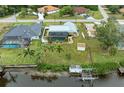 Aerial view of canal-front property with a pool and private dock at 3438 Yukon Dr, Port Charlotte, FL 33948