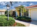 Landscaped front yard with walkway leading to entryway of house at 3716 Eagle Hammock Dr, Sarasota, FL 34240