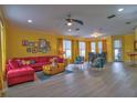 Bright living room with red couch and colorful armchairs at 3906 Chaucer Ln, Sarasota, FL 34241