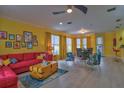 Bright living room with red couch and colorful armchairs at 3906 Chaucer Ln, Sarasota, FL 34241