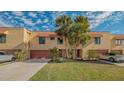 Two-story townhouse with red roof and palm trees at 4009 Catalina Dr # 178, Bradenton, FL 34210