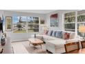 Light-filled living room featuring a sectional sofa and large windows at 4350 Chatham Dr # 208, Longboat Key, FL 34228