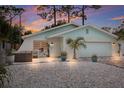 Charming house exterior at dusk, featuring unique landscaping and lighting at 4534 Pike Ave, Sarasota, FL 34233