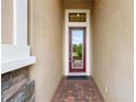 Inviting entryway with red door and brick flooring at 4653 Royal Dornoch Cir, Bradenton, FL 34211