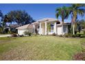 One-story house with beige exterior and palm trees at 4821 Hanging Moss Ln, Sarasota, FL 34238