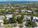 Aerial view highlighting a home nestled in a quiet, tree-lined neighborhood at 4857 Primrose Path, Sarasota, FL 34242