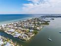 Wide aerial showcasing waterfront property and surrounding neighborhood at 512 Bayview Pl, Anna Maria, FL 34216