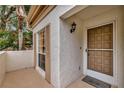 Condo entry with brown door and small patio at 5248 Marshfield Ln # 2, Sarasota, FL 34235