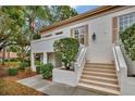 Side view of condo building with stairs and landscaping at 5248 Marshfield Ln # 2, Sarasota, FL 34235