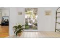 View of interior courtyard through a window from inside the house at 5532 Country Club Way, Sarasota, FL 34243