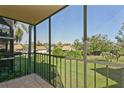 Screened balcony overlooking a lush green lawn and other buildings at 618 Bird Bay S Dr # 206, Venice, FL 34285