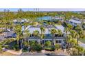 Aerial view of condo building, highlighting its architecture and proximity to water at 6750 Gulf Of Mexico Dr # 153, Longboat Key, FL 34228