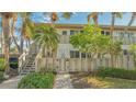 Condo exterior featuring a private entrance, stairs, and landscaped surroundings at 6750 Gulf Of Mexico Dr # 153, Longboat Key, FL 34228