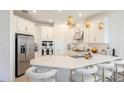 Modern kitchen with white cabinets and a large island at 8612 Evening Dr, Sarasota, FL 34241