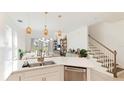 Modern white kitchen with stainless steel appliances at 8612 Evening Dr, Sarasota, FL 34241