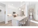 Spacious kitchen with white cabinets, island, and stainless steel appliances at 883 Seascape Pl, Sarasota, FL 34240