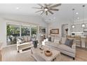 Bright and airy living room with comfy sofas and sliding doors leading to the pool at 883 Seascape Pl, Sarasota, FL 34240