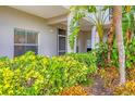 Condo entry with lush landscaping and screened door at 9620 Club South Cir # 5102, Sarasota, FL 34238