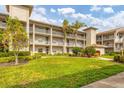 Condo building with green lawn and palm trees at 9620 Club South Cir # 5102, Sarasota, FL 34238