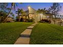 Two-story home with walkway leading to entrance, surrounded by palm trees at 10106 46Th W Ave, Bradenton, FL 34210