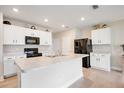 Modern kitchen featuring white cabinets and a large island at 10210 Mangrove Well Rd, Sun City Center, FL 33573