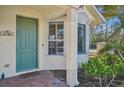 Quaint entryway with a green door and bay window at 1110 Beachcomber Ct # 1, Osprey, FL 34229