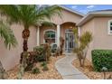 Welcoming front entry with a walkway, landscaping, and a teal door at 11921 Whistling Way, Lakewood Ranch, FL 34202