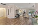 Spacious living room with hardwood floors, a sitting area, and views to the pool at 11921 Whistling Way, Lakewood Ranch, FL 34202