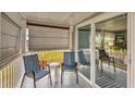 Covered porch with two chairs and sliding glass door access at 1210 41St Avenue E Dr, Ellenton, FL 34222