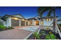 Two-story home with a three-car garage and landscaped front yard at 1210 Blue Shell Loop, Sarasota, FL 34240