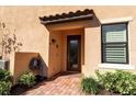 Townhome front entrance with brick walkway and small garden at 12550 Ghiberti Cir # 101, Venice, FL 34293