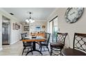 Dining area with dark wood table and chairs, near kitchen at 1737 Bonitas Cir # 1724D, Venice, FL 34293