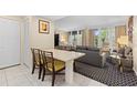 Small dining area with seating for four and access to the living room at 250 Sands Point Rd # 5105, Longboat Key, FL 34228