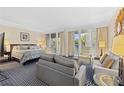 Spacious main bedroom with sitting area and access to the balcony at 250 Sands Point Rd # 5105, Longboat Key, FL 34228