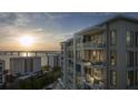 Exterior view of condo building featuring multiple balconies and water views at 325 Golden Gate Pt # 704, Sarasota, FL 34236