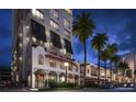 Luxury building exterior at night, featuring Spanish-style architecture and palm trees at 33 S Palm Ave # 1601, Sarasota, FL 34236