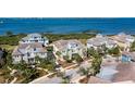 Aerial view of waterfront homes with lush landscaping and scenic water views at 330 Compass Point Dr # 101, Bradenton, FL 34209