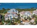 Aerial view showcasing a charming waterfront home with a private walkway at 330 Compass Point Dr # 101, Bradenton, FL 34209