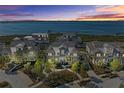 Sunset view of an attractive waterfront community, boasting lush greenery and stunning bay vistas at 330 Compass Point Dr # 101, Bradenton, FL 34209