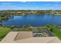 Aerial view of the house and backyard pool area overlooking the lake at 4790 Sweetshade Dr, Sarasota, FL 34241