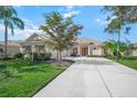 House exterior showcasing a two-car garage and a manicured lawn at 4790 Sweetshade Dr, Sarasota, FL 34241
