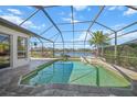 Relaxing screened pool and spa with a view of the lake at 4790 Sweetshade Dr, Sarasota, FL 34241