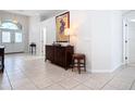 Bright and airy foyer with tiled flooring and a stylish console table at 5062 Flagstone Dr, Sarasota, FL 34238