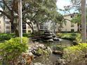 Peaceful courtyard with a fountain and lush landscaping at 515 30Th W Ave # H207, Bradenton, FL 34205