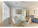 Bright dining area with glass table and wicker chairs at 5938 Welcome Rd # H22, Bradenton, FL 34207