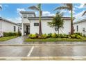 Modern house with a walkway leading to the entrance at 6404 Pigeon Plum Way, Bradenton, FL 34210