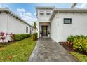 Modern home's entrance with walkway and landscaping at 6404 Pigeon Plum Way, Bradenton, FL 34210