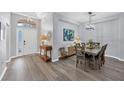 Bright dining room with a table, chairs, and hardwood floors at 6650 Cheswick St, Sarasota, FL 34243